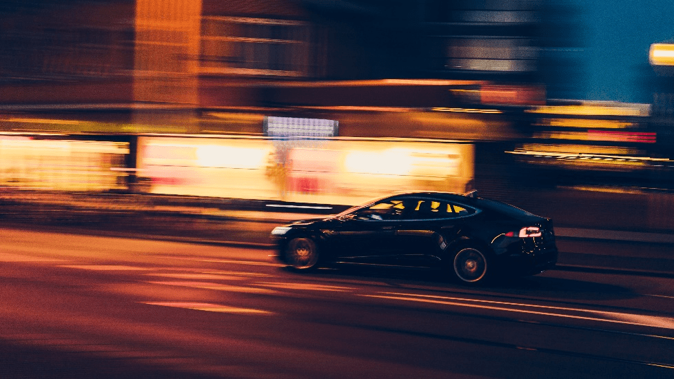 An EV going fast down the road.