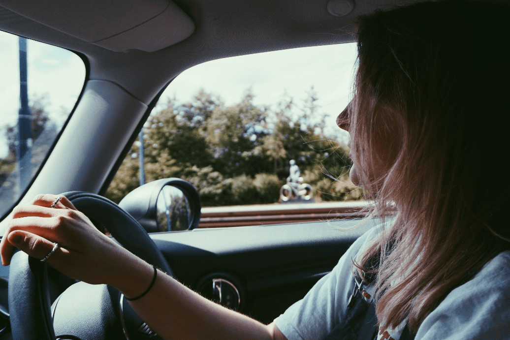 A person driving a PCO rental car.