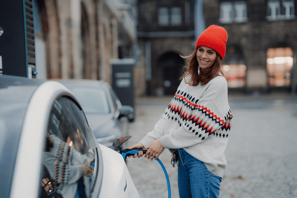 A woman is charging her electric car in Chelsea