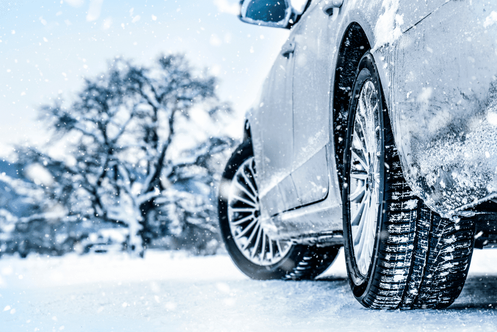  A car driving in snowy weather 