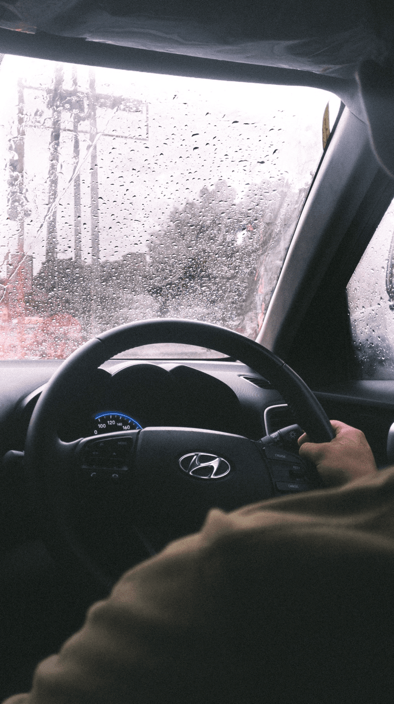 A person driving in the rain